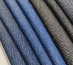 Close-up texture of modal blended denim fabric showing a smooth surface and soft indigo finish for lightweight apparel.