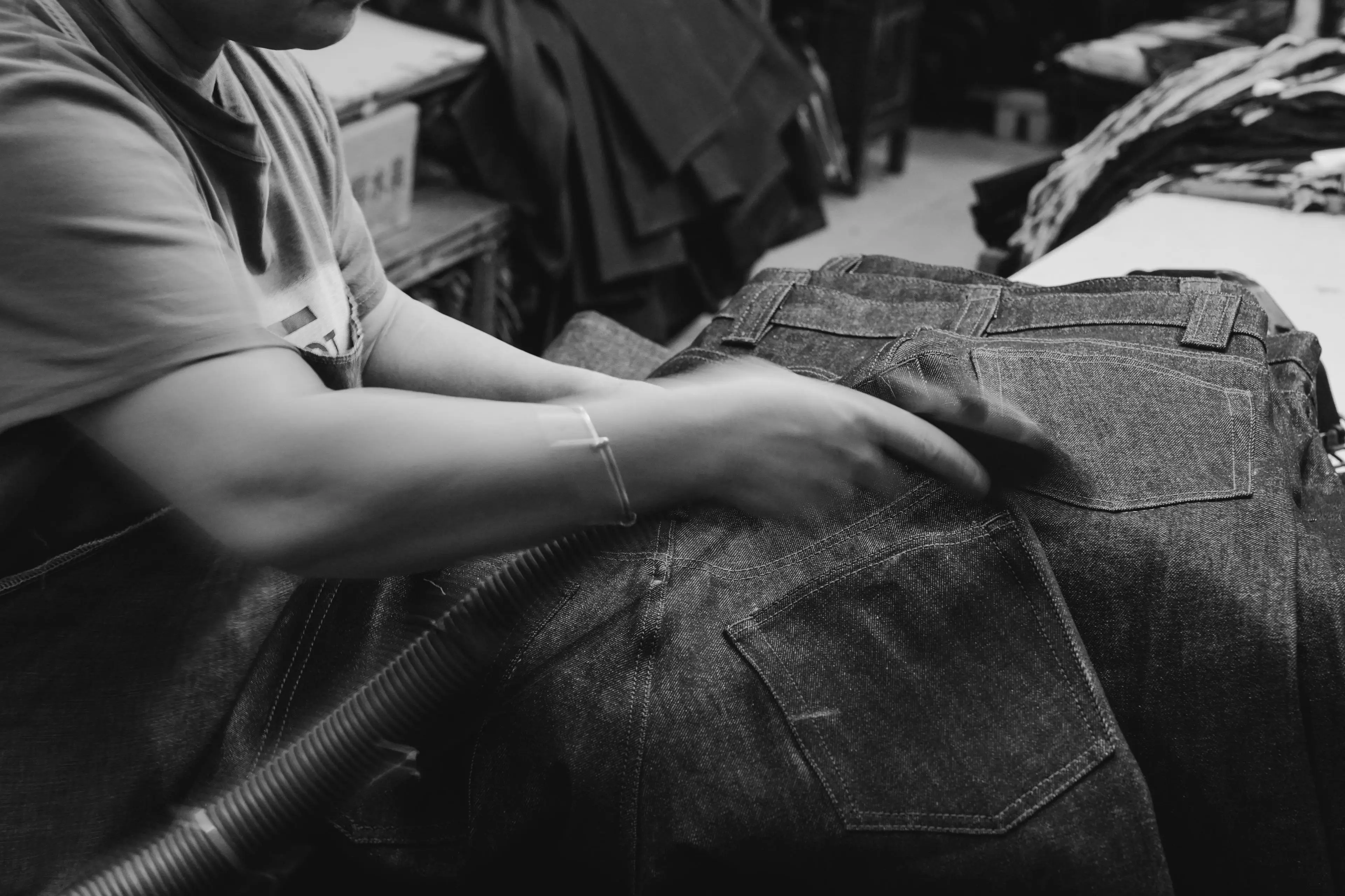 denim fabric weight - worker inspecting denim quality and garment durability