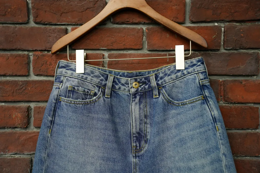 reego denim jeans waistband distressed brick wall