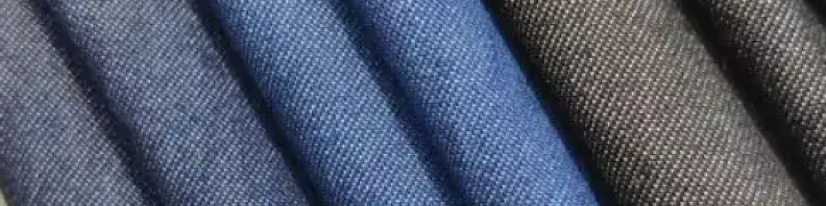 Close-up texture of modal blended denim fabric showing a smooth surface and soft indigo finish for lightweight apparel.